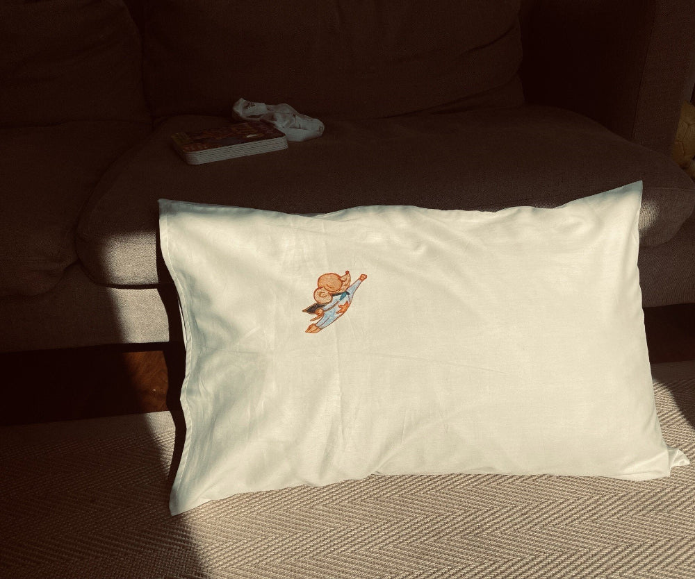 Sukun Mighty Mouse White pillow with cartoon character on a brown couch