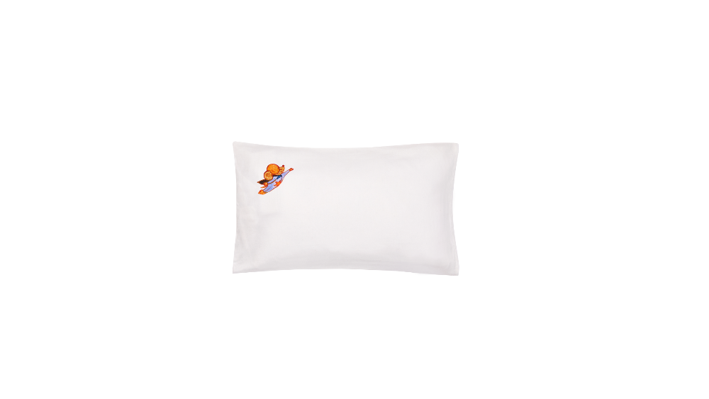 White pillow with a small embroidered design on a white background