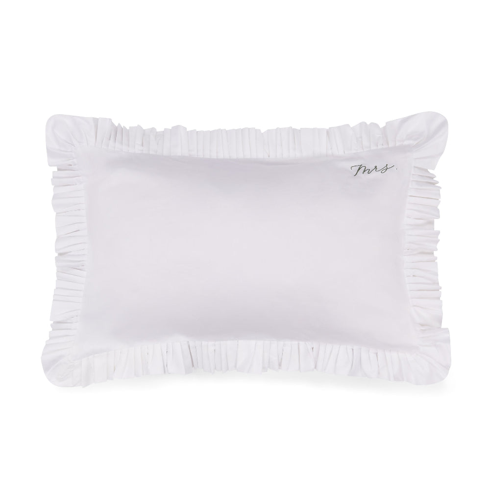 White pillow with ruffled edge and 'Mrs.' embroidery on a white background