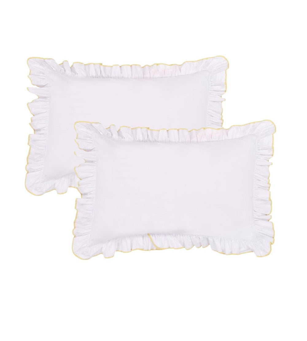 Two white bedroom pillows with ruffled edges on a white background