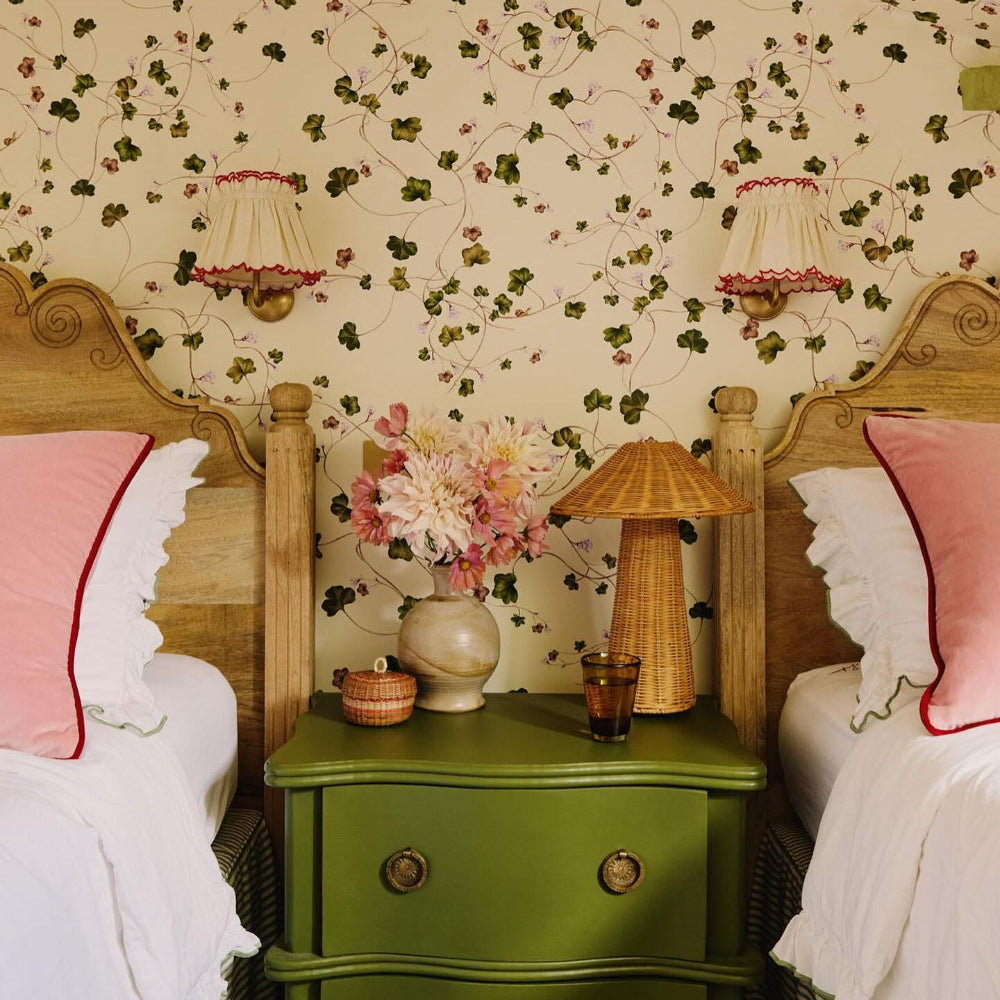 Vintage bedroom with floral wallpaper, wooden bed frames, and a green nightstand with Provence Olive Bedding set by Sukun