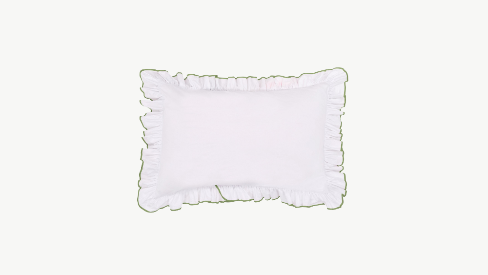 White pillow with Olive coloured ruffled edges on a cream background