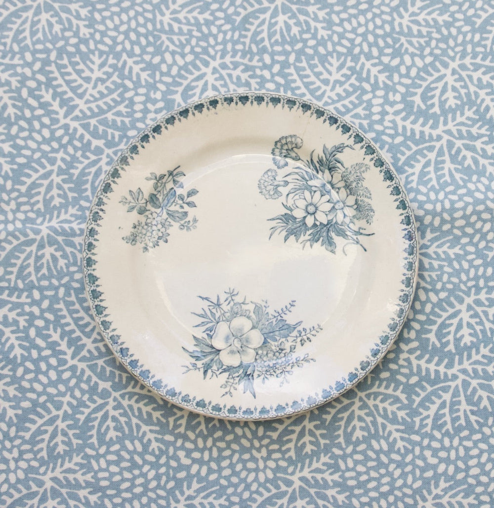 Decorative plate with floral patterns on a matching fabric background