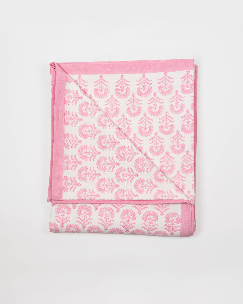 Pink and white patterned tablecloth on a light grey background