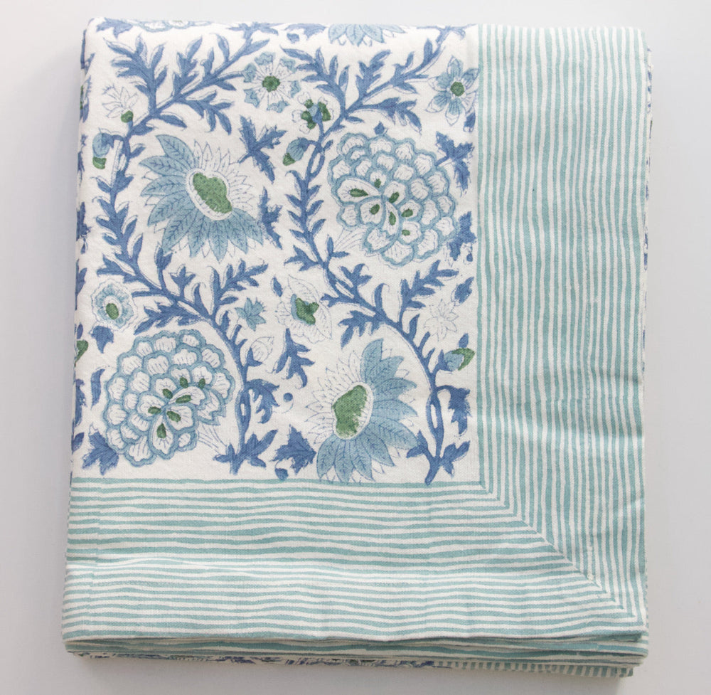 Folded Tablecloth with blue floral patterns on a white background