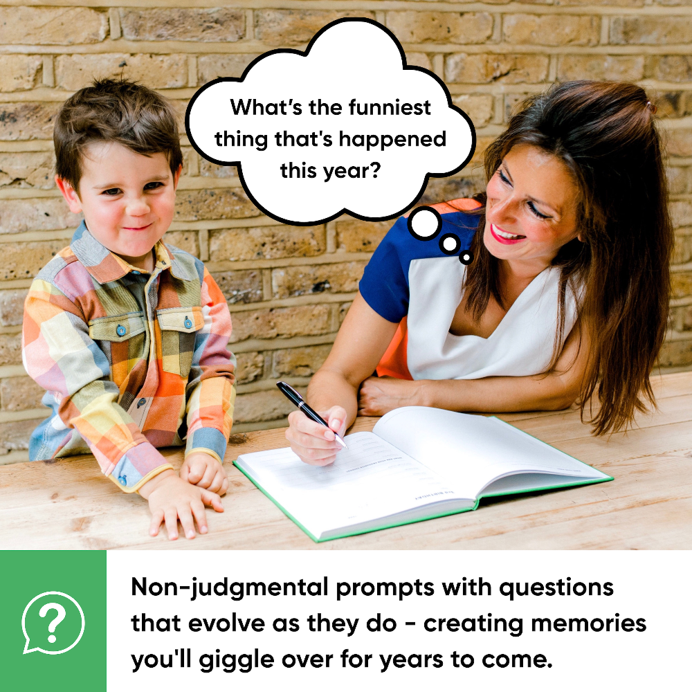 Woman and child sitting at a table with a notebook, engaged in conversation.