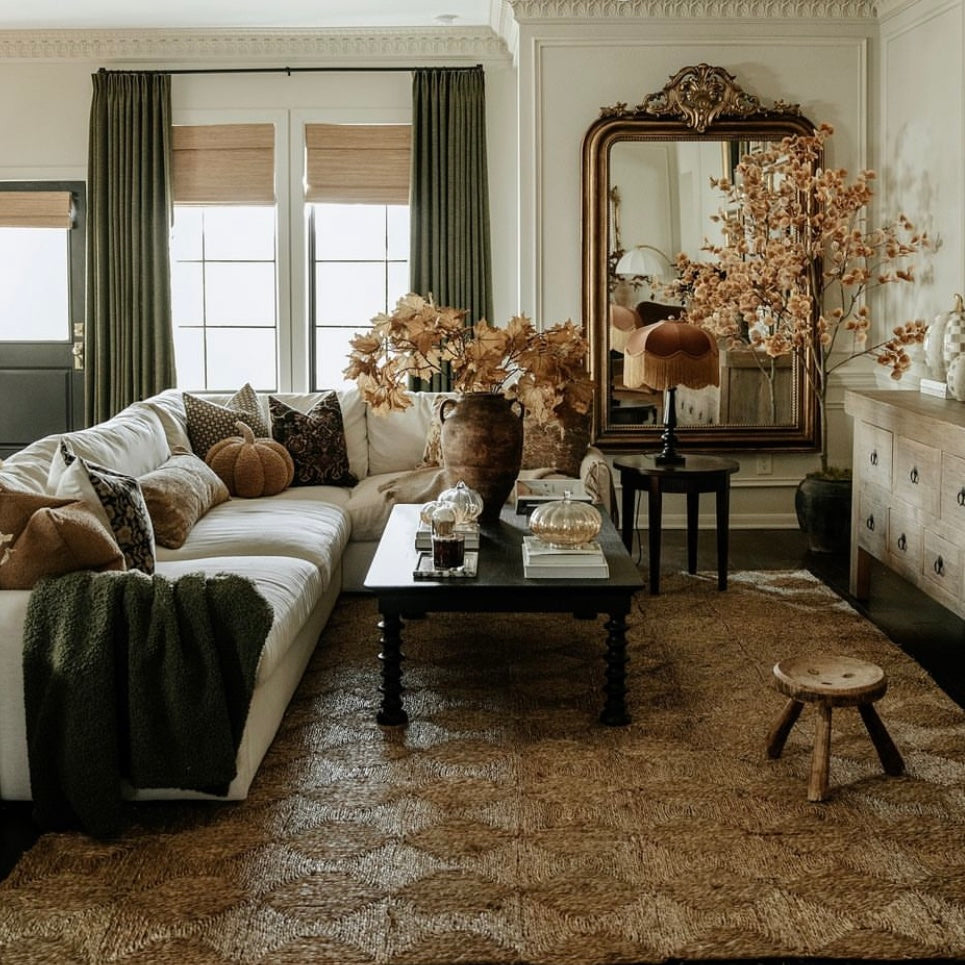 Cozy living room with a beige sectional sofa, decorative pillows, and a coffee table.