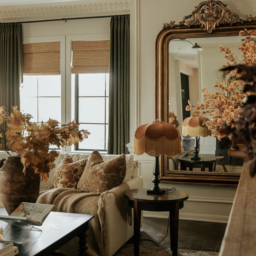 Autumnal Living room with a couch, lamp, and decorative mirror.