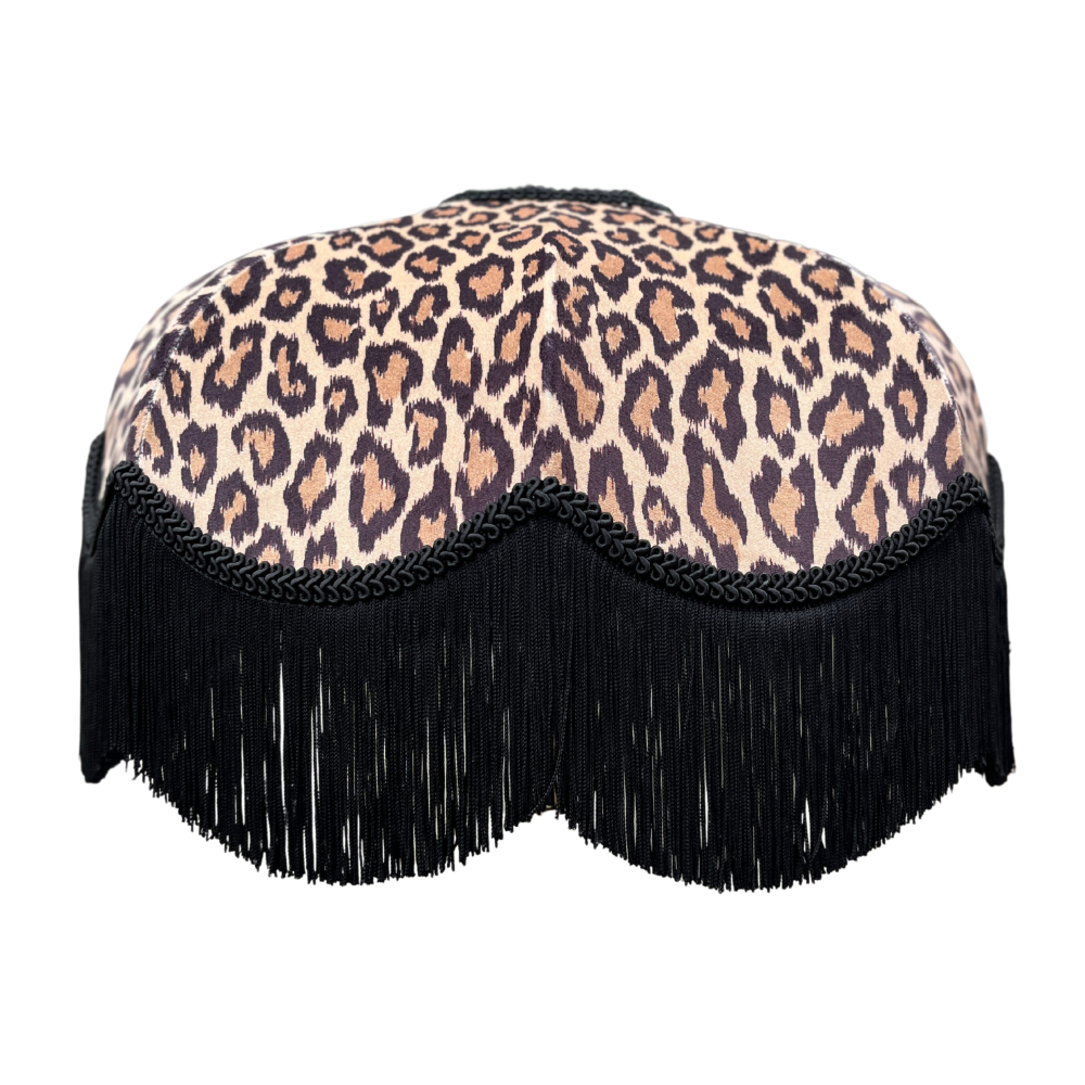 Leopard print lampshade with black fringe on a white background