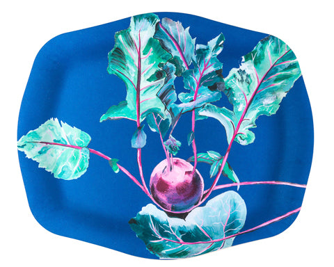 Blue plate with a decorative design of purple radishes and green leaves on a white background