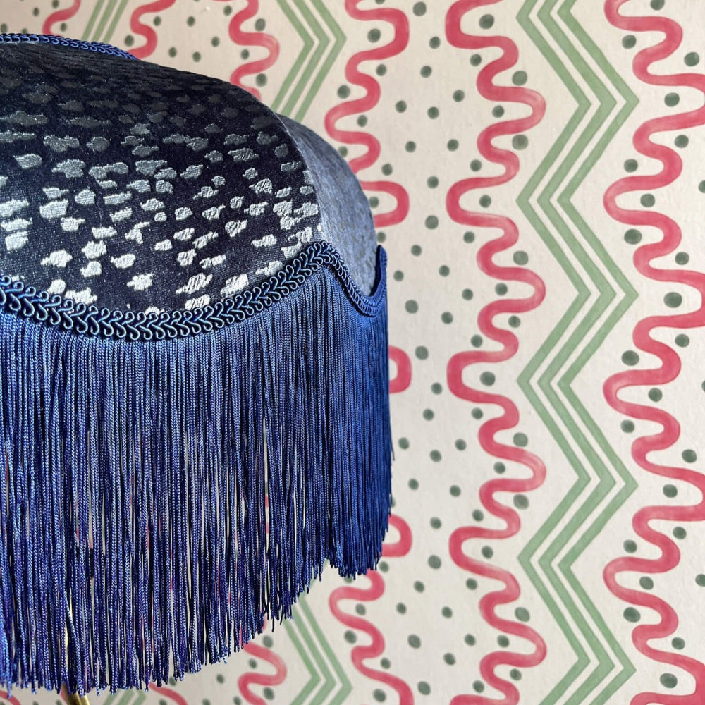 The Gatsby Fringed Lampshade on a colourful zigzag-patterned background
