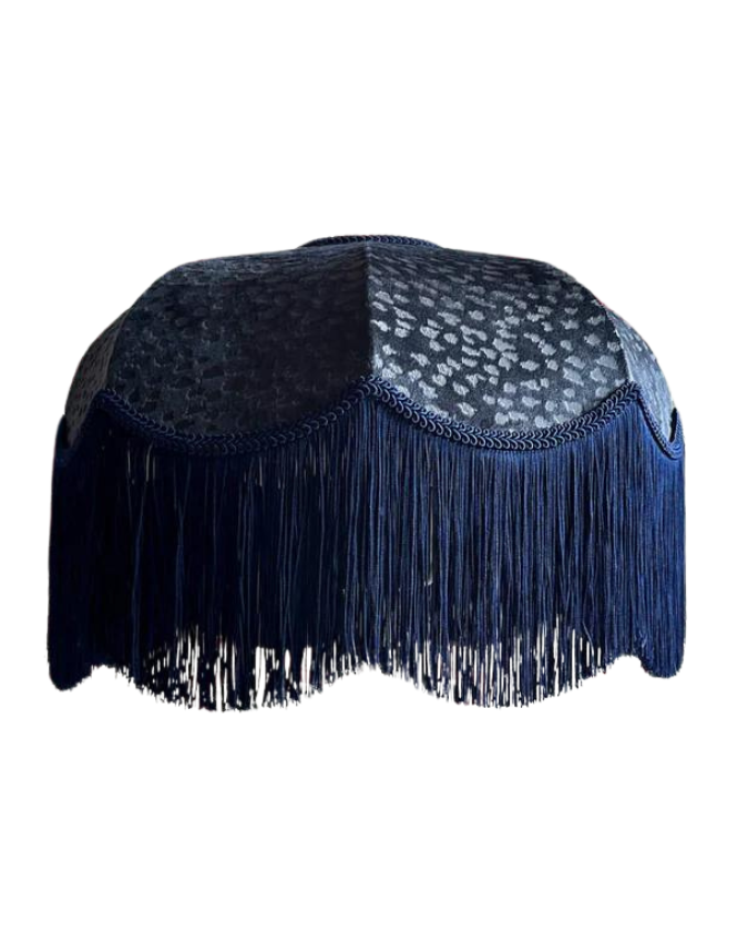 Navy blue Lampshade with fringe and patterned top on a white background