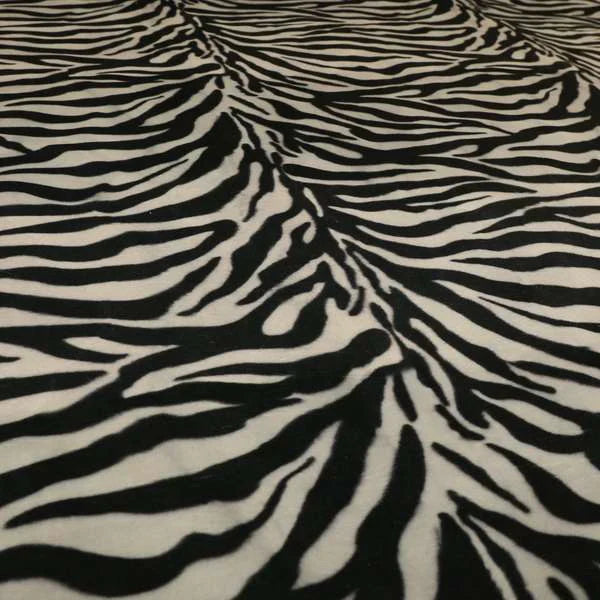 Close-up of zebra print fabric with black and white stripes.