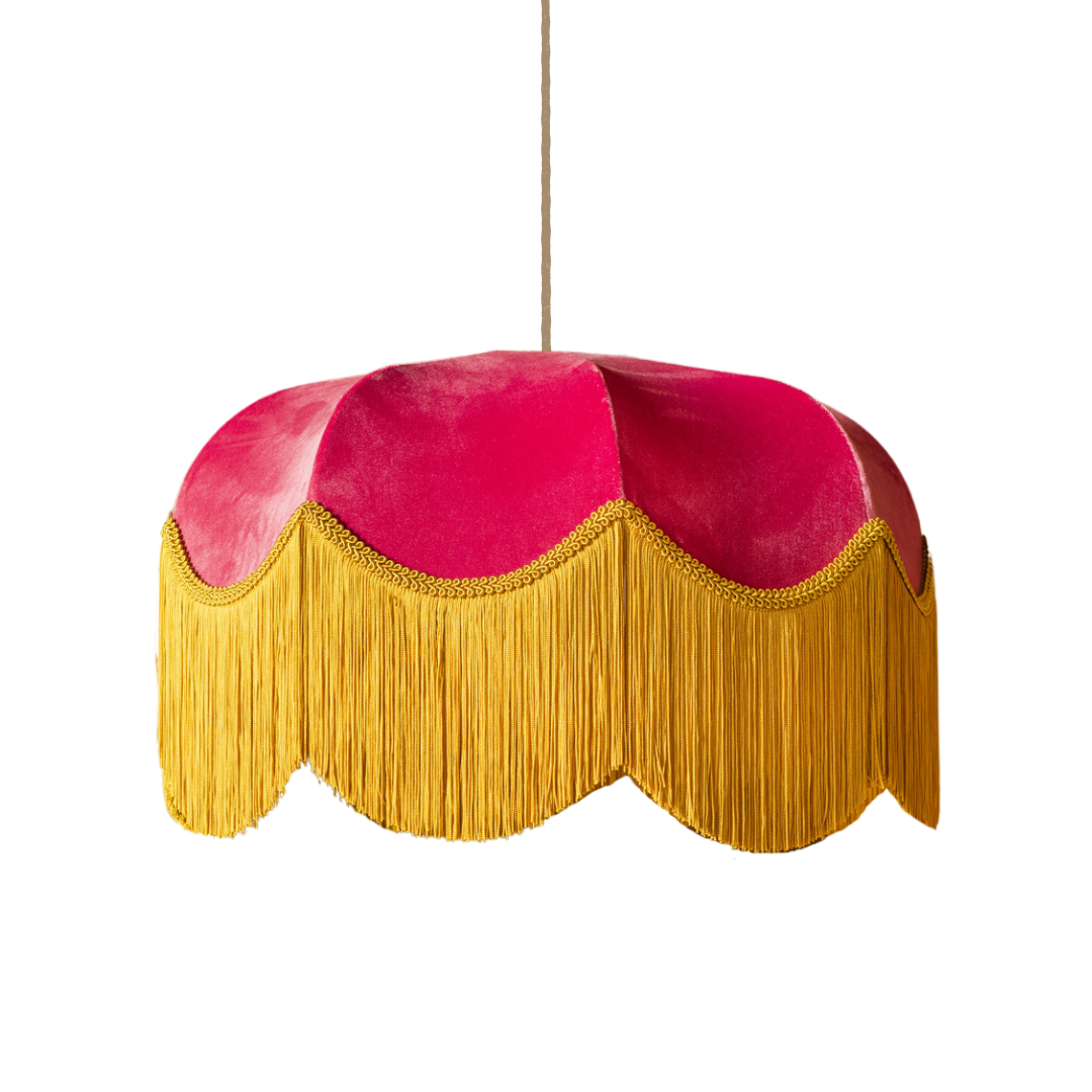 Pink and gold lampshade with fringe on a white background