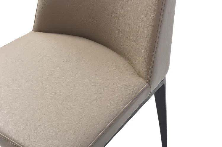 Close-up of Tommy Franks Medici sand upholstered dining chair with a white background