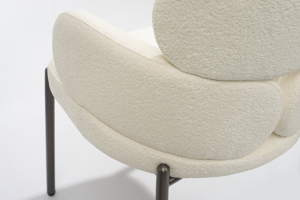 Tommy Franks Dream Boucle Dining Chair  with curved design and beige fabric on a white background