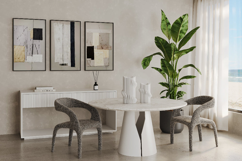 Escada Dining chairs in a Modern dining room with a white round table, grey chairs, and decorative elements.