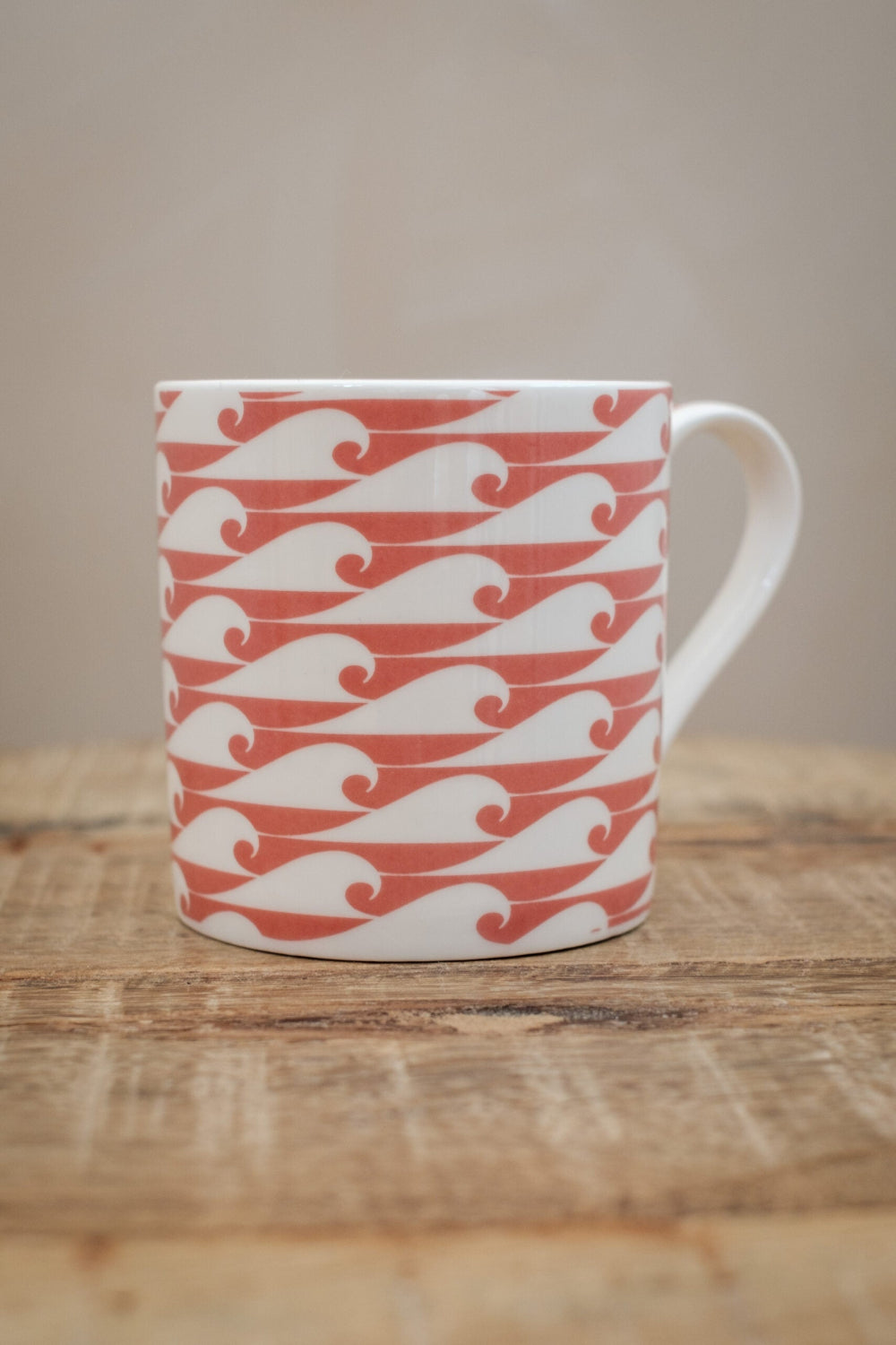 Wild Salmon Wave patterned mug on a wooden table