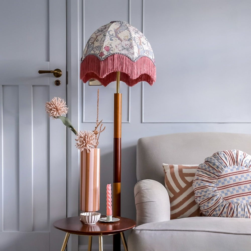 Decorative floor lamp with floral shade in a living room setting.