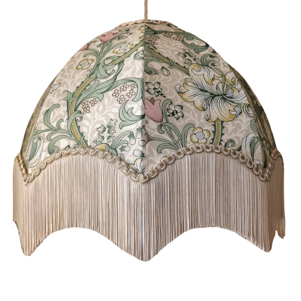 Decorative lampshade with floral patterns and fringe on a white background