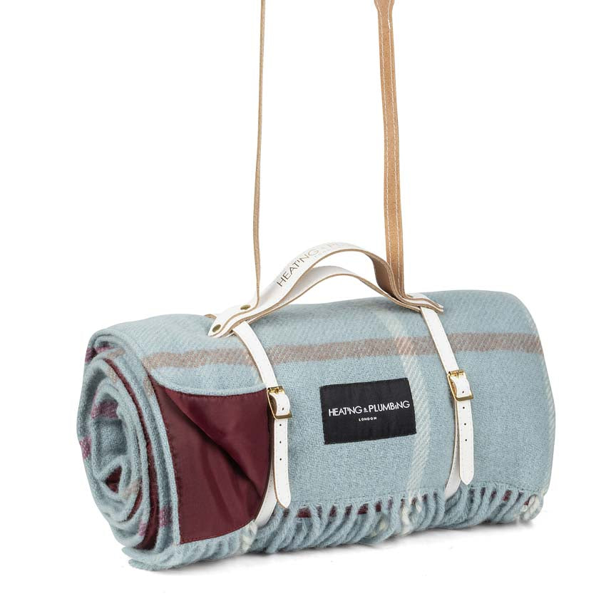 Roll-up Duck Egg coloured picnic blanket with carrying strap on a white background