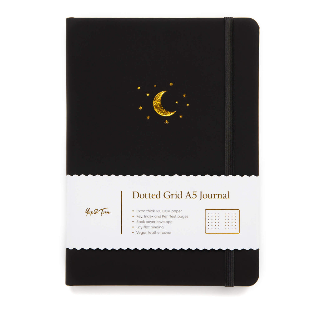 Yop & Tom Black dotted grid A5 journal with gold moon design on a white background