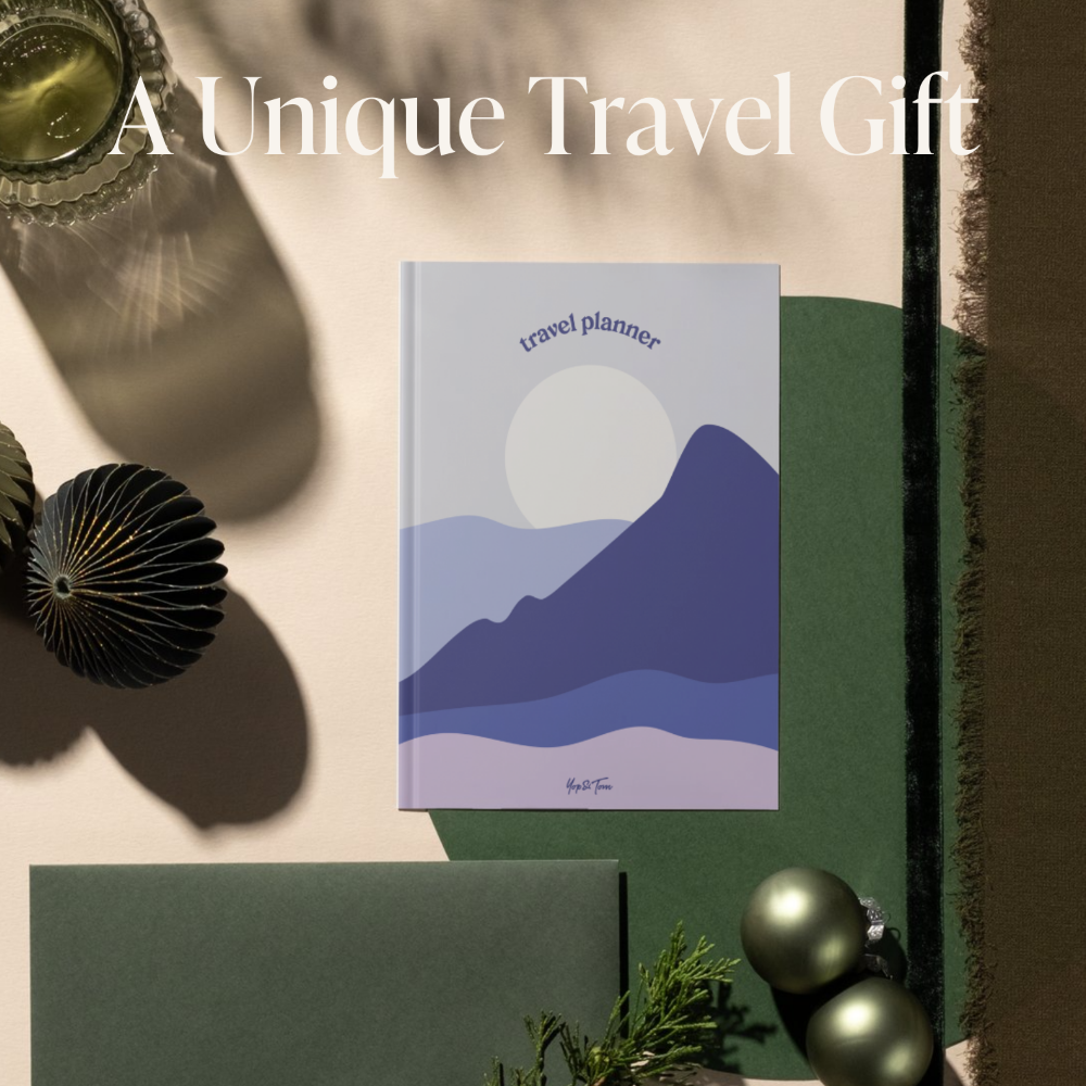 Travel planner book with mountain design on a decorative background