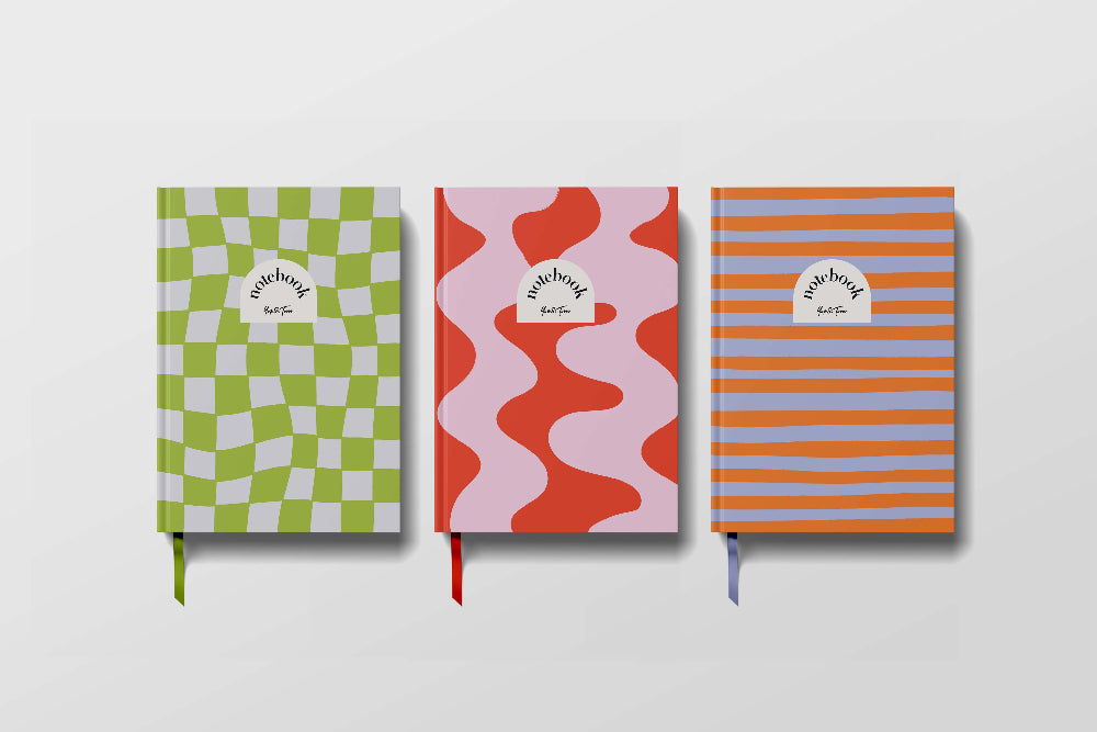 Three colourful notebooks with different patterns on a white background
