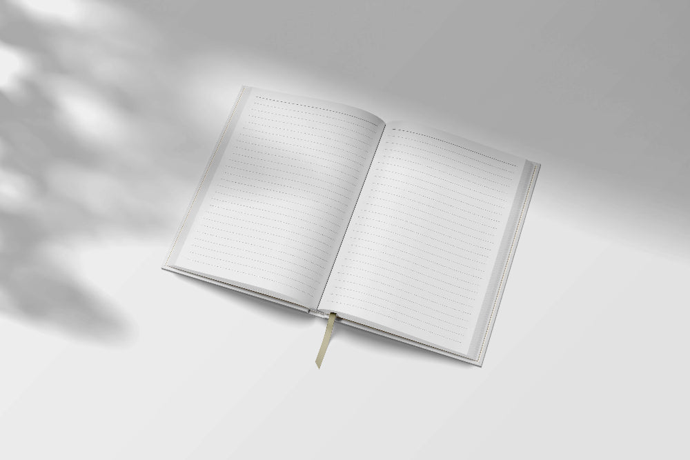 Open notebook with lined pages on a light grey background