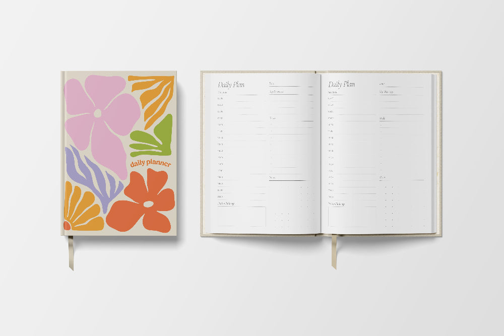 Floral planner cover with open planner showing daily plan layout on a white background