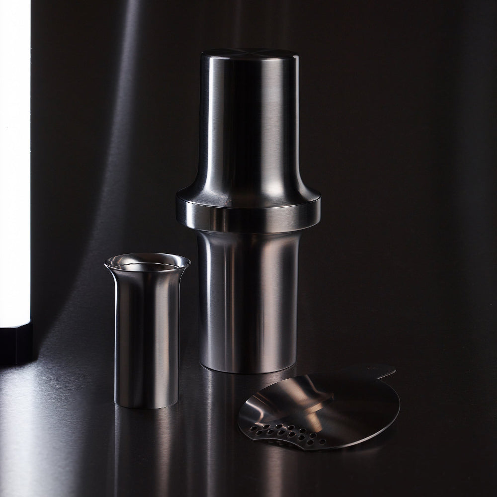 BARBICAN cocktail strainer by Aaron Probyn displayed beside the coordinating stainless steel shaker and jigger