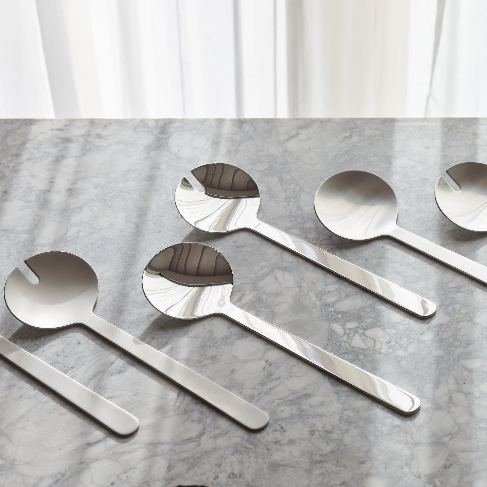 Aaron Probyn BOROUGH polished stainless steel salad serving spoon and slotted spoon on grey marble