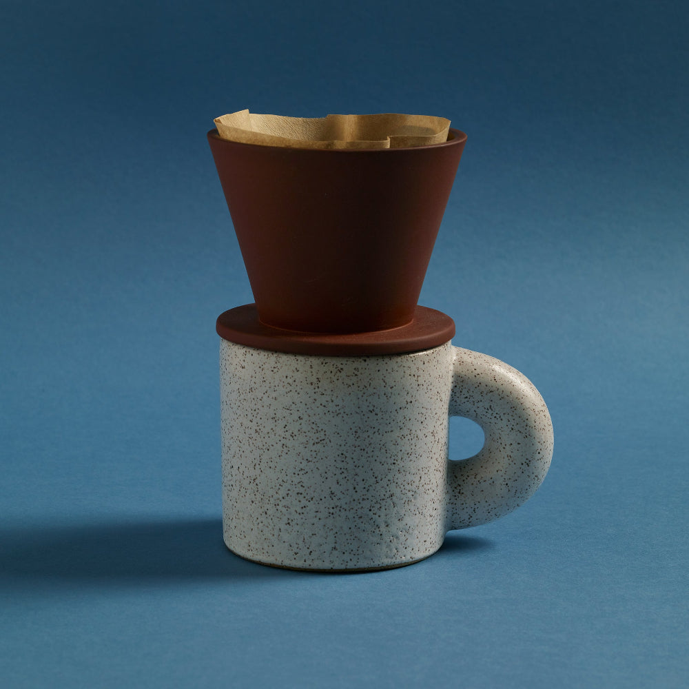 COLOMBO terracotta pour-over coffee dripper on a speckled stoneware mug