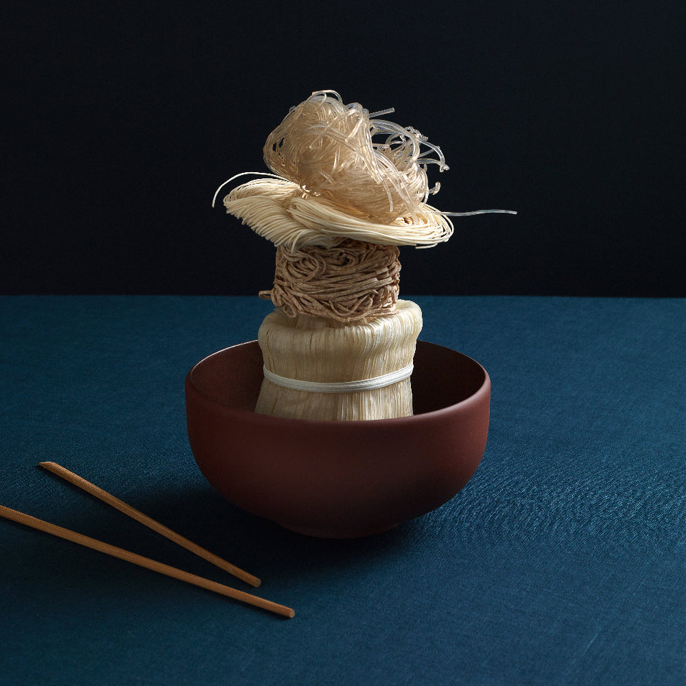 Terracotta COLOMBO ramen bowl by Aaron Probyn with an arrangement of noodles and chopsticks