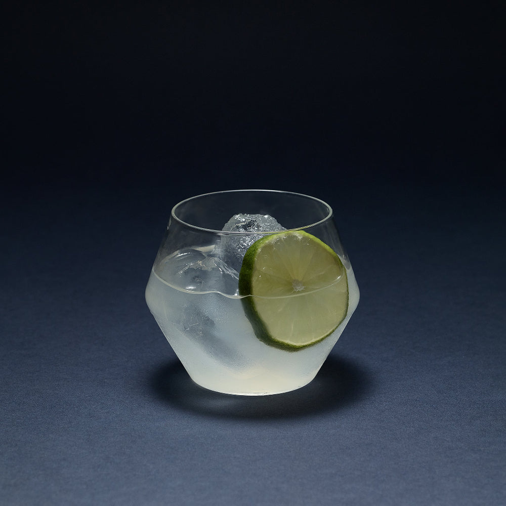 Clear JUNIPER short tumbler glass by Aaron Probyn with a sculptural geometric shape