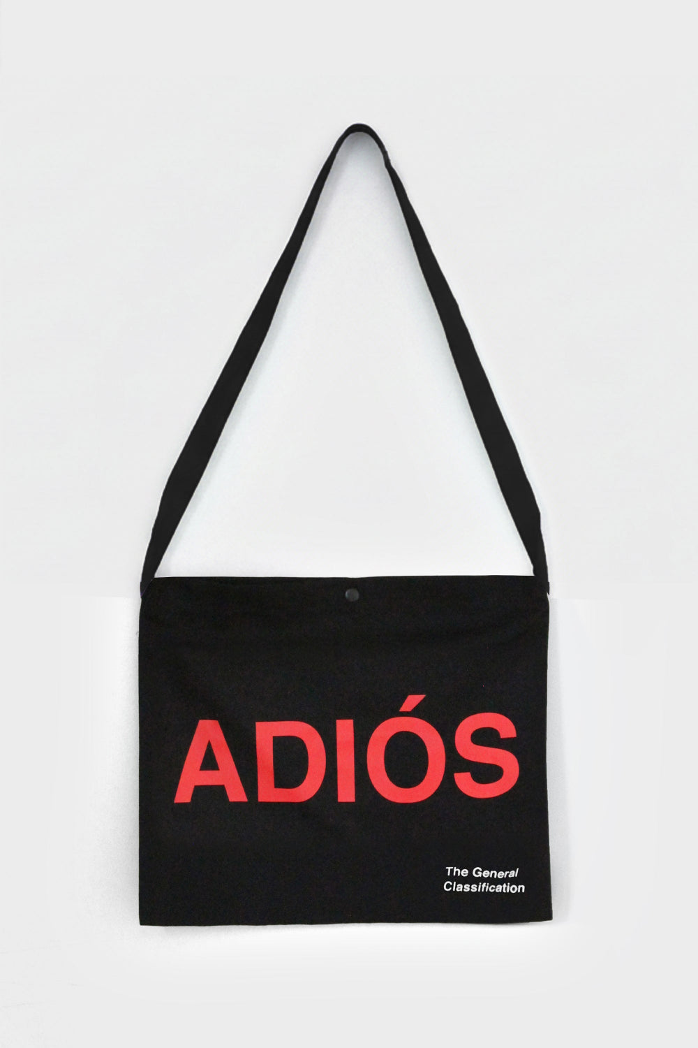 Black tote bag with red 'ADIÓS' text on a white background