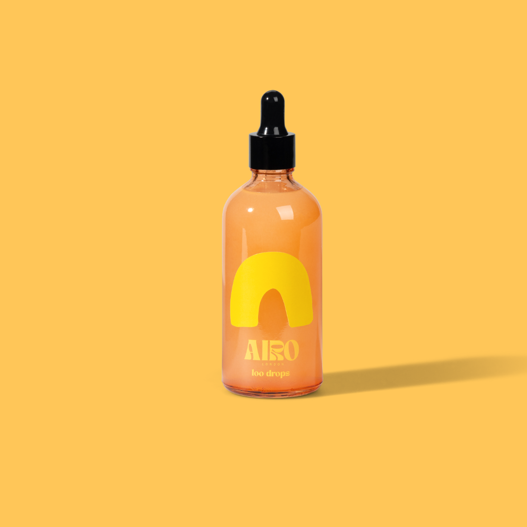 Bottle of Airo loo drops to help with smells in the toilet on a yellow background