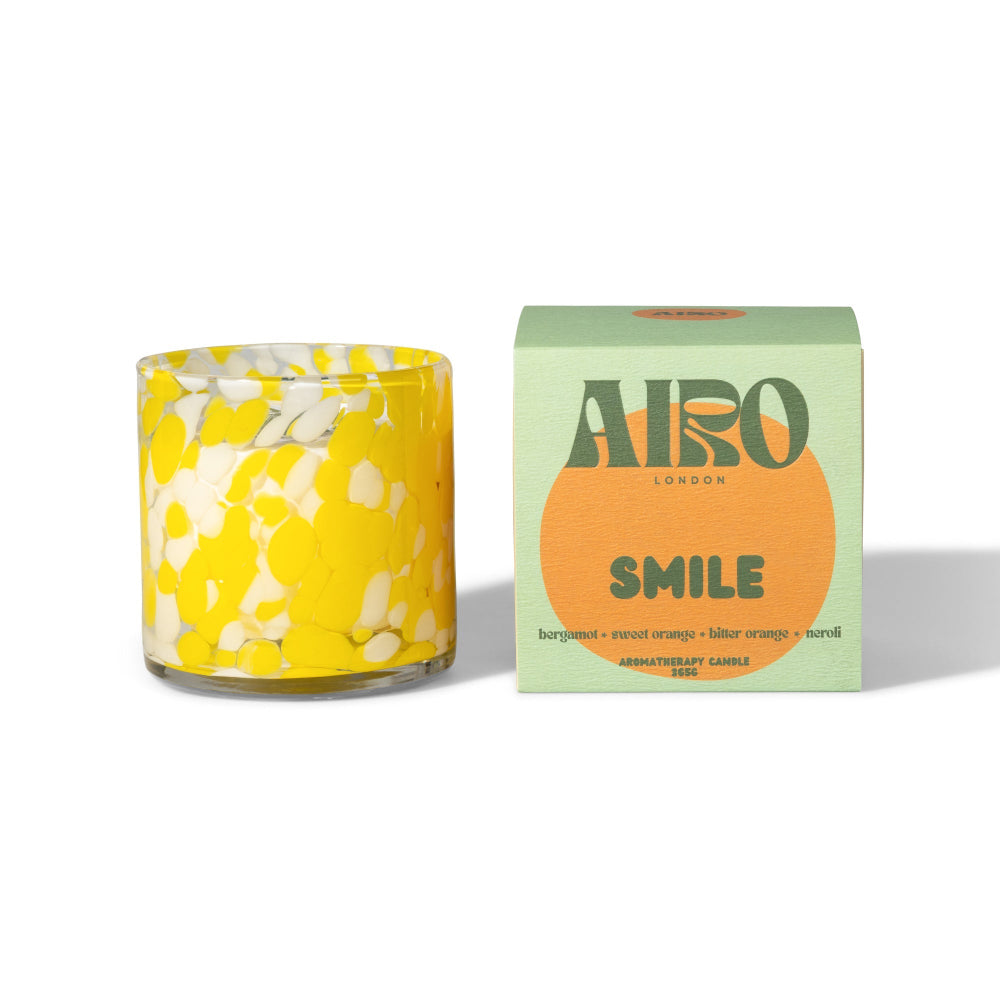 Yellow floral candle with Airo London packaging on a white background