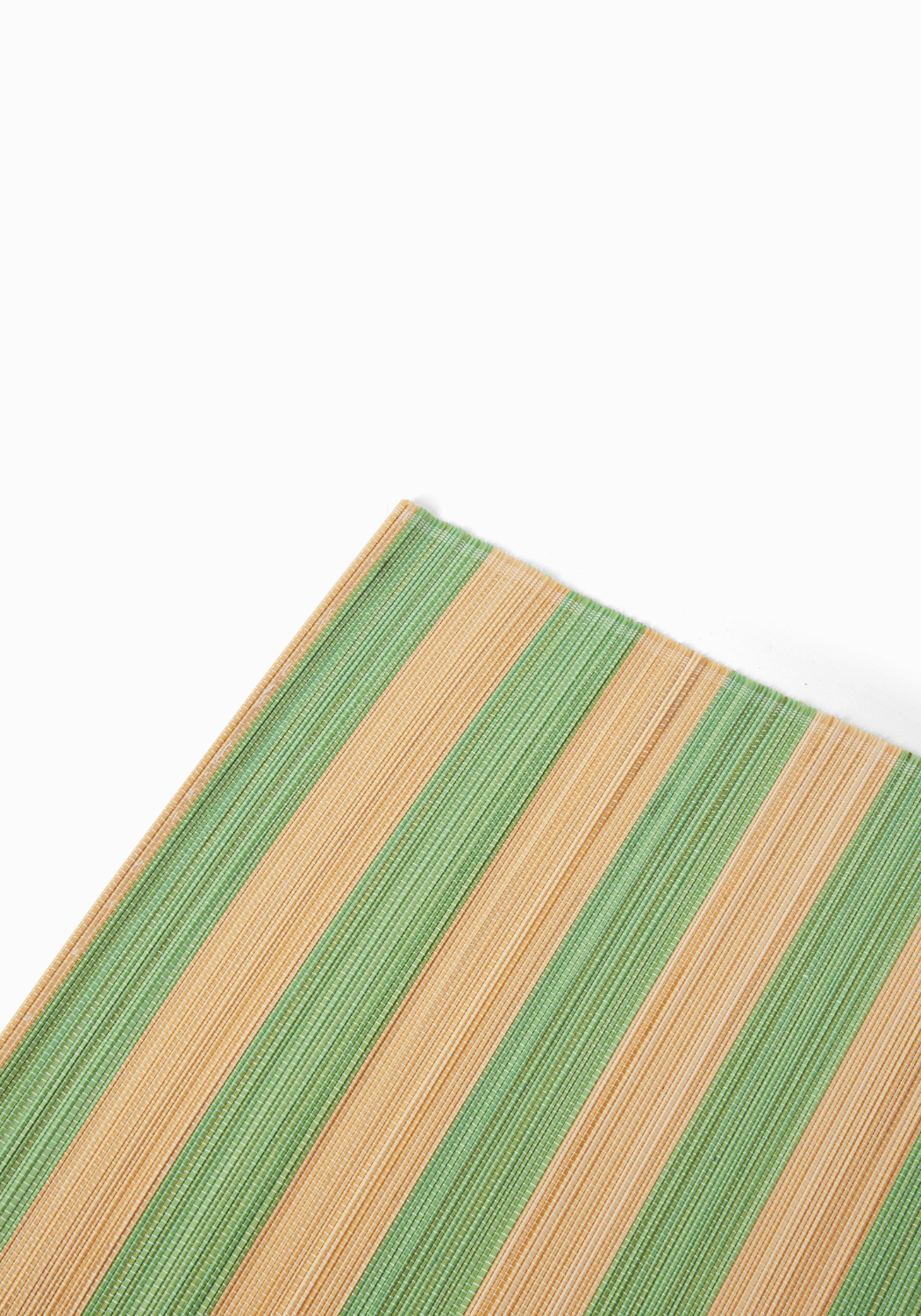 Close-up of a green and beige striped patterned placemat Amalfi coast inspired on a white background