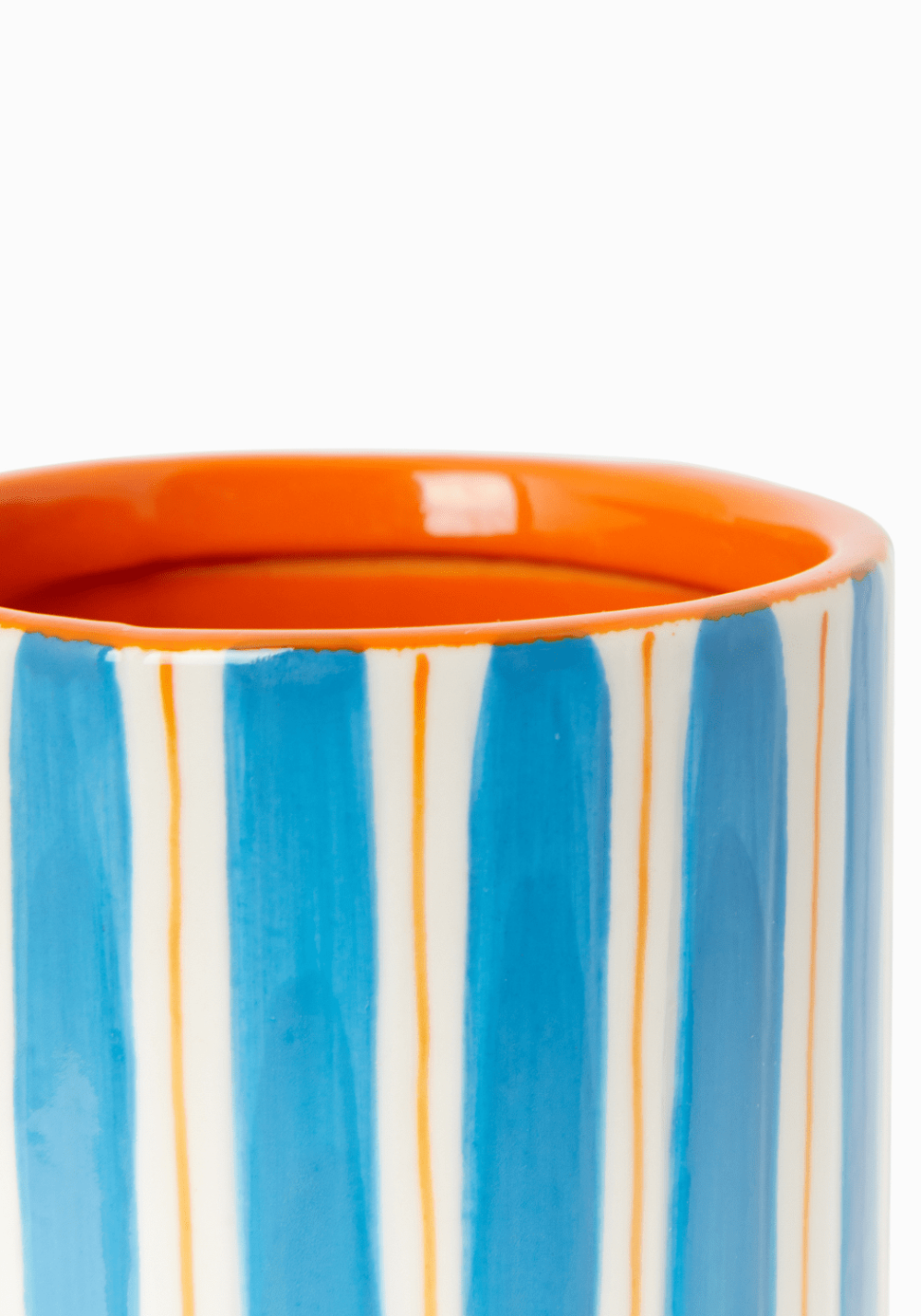Ceramic vase with blue and white striped design and orange rim on a white background