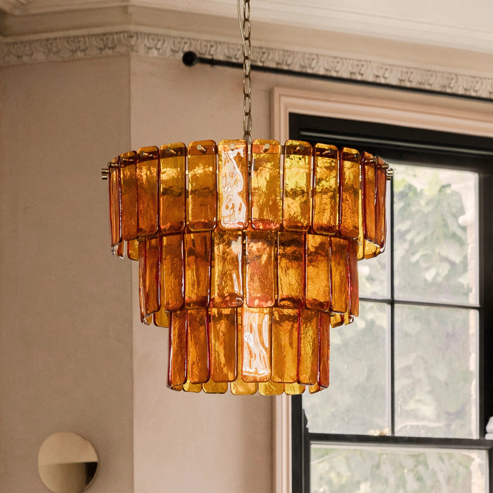 Amber and brass chandelier styled in a contemporary interior