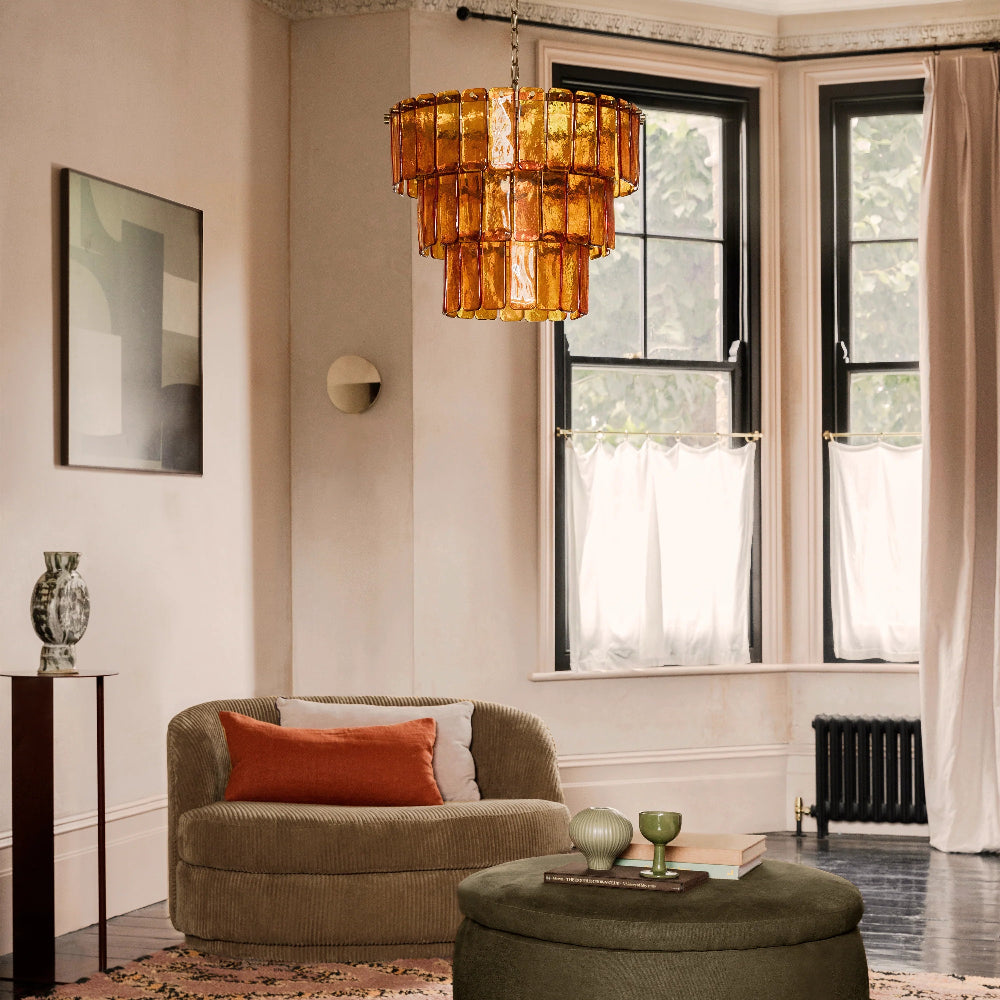 Amber glass chandelier styled above a living room