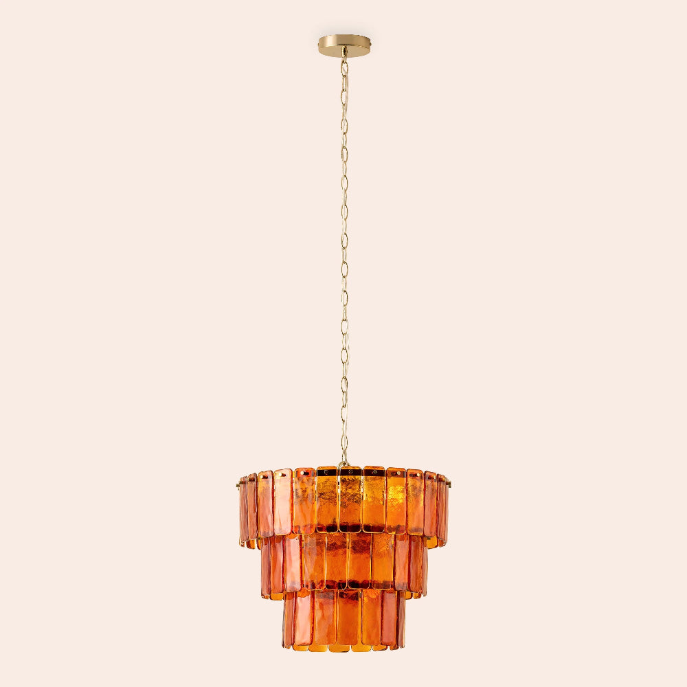 Amber glass ceiling light switched on with warm golden glow