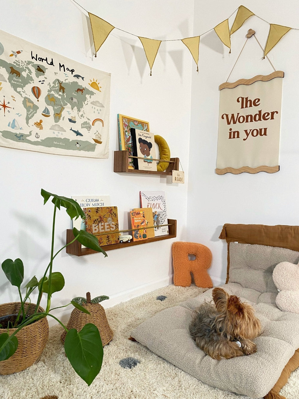 Children's room with world map, books, and decorative elements.