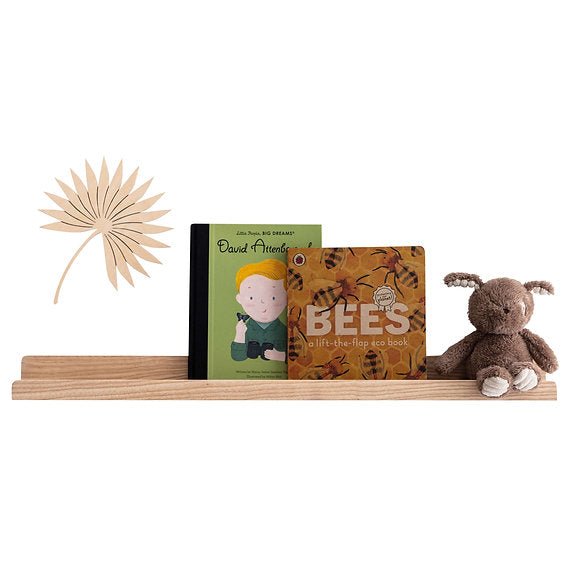 Wooden shelf with children's books and a plush toy on a white background