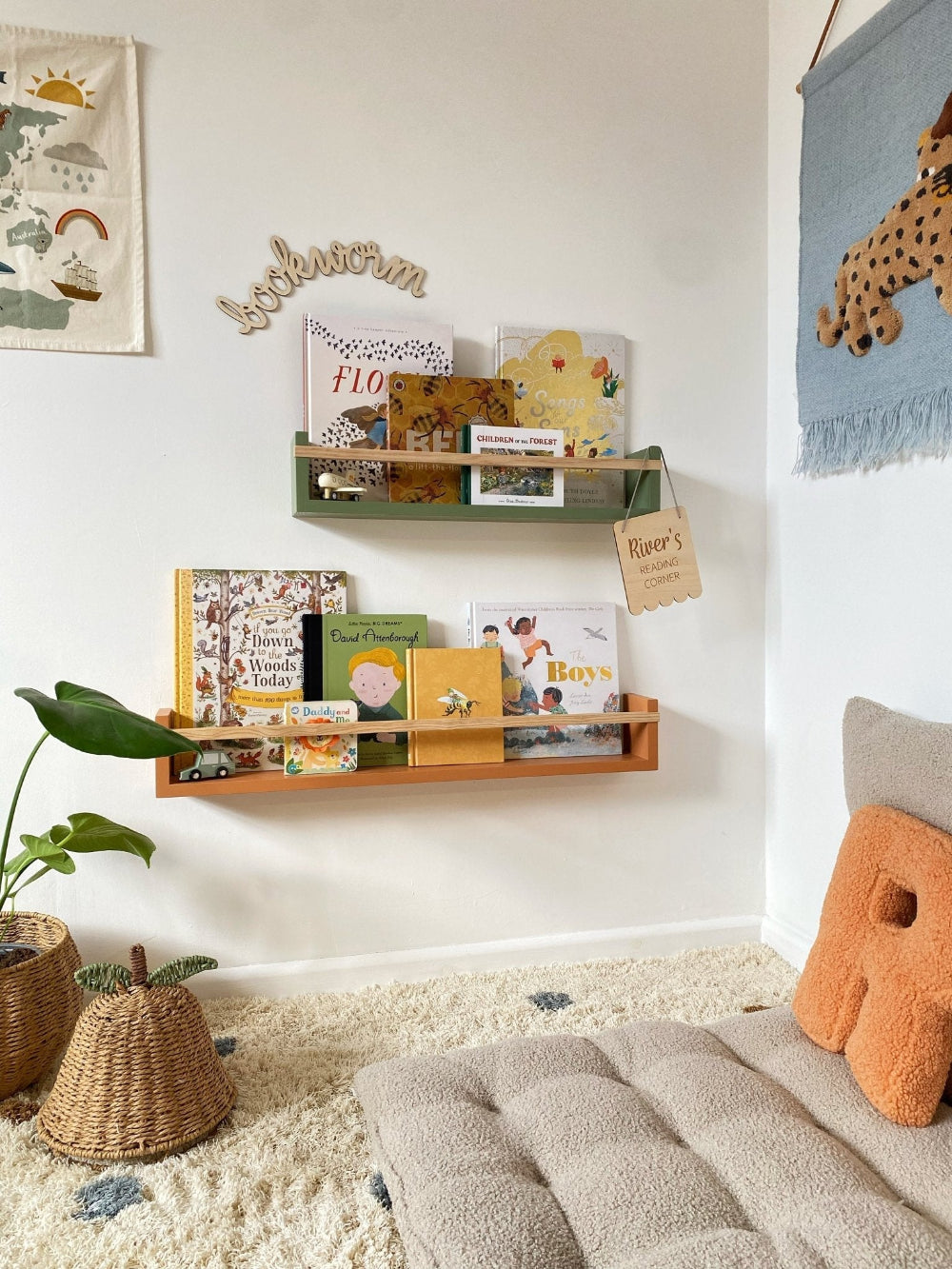 Children's room with bookshelf, books, and decorative items on a white wall.