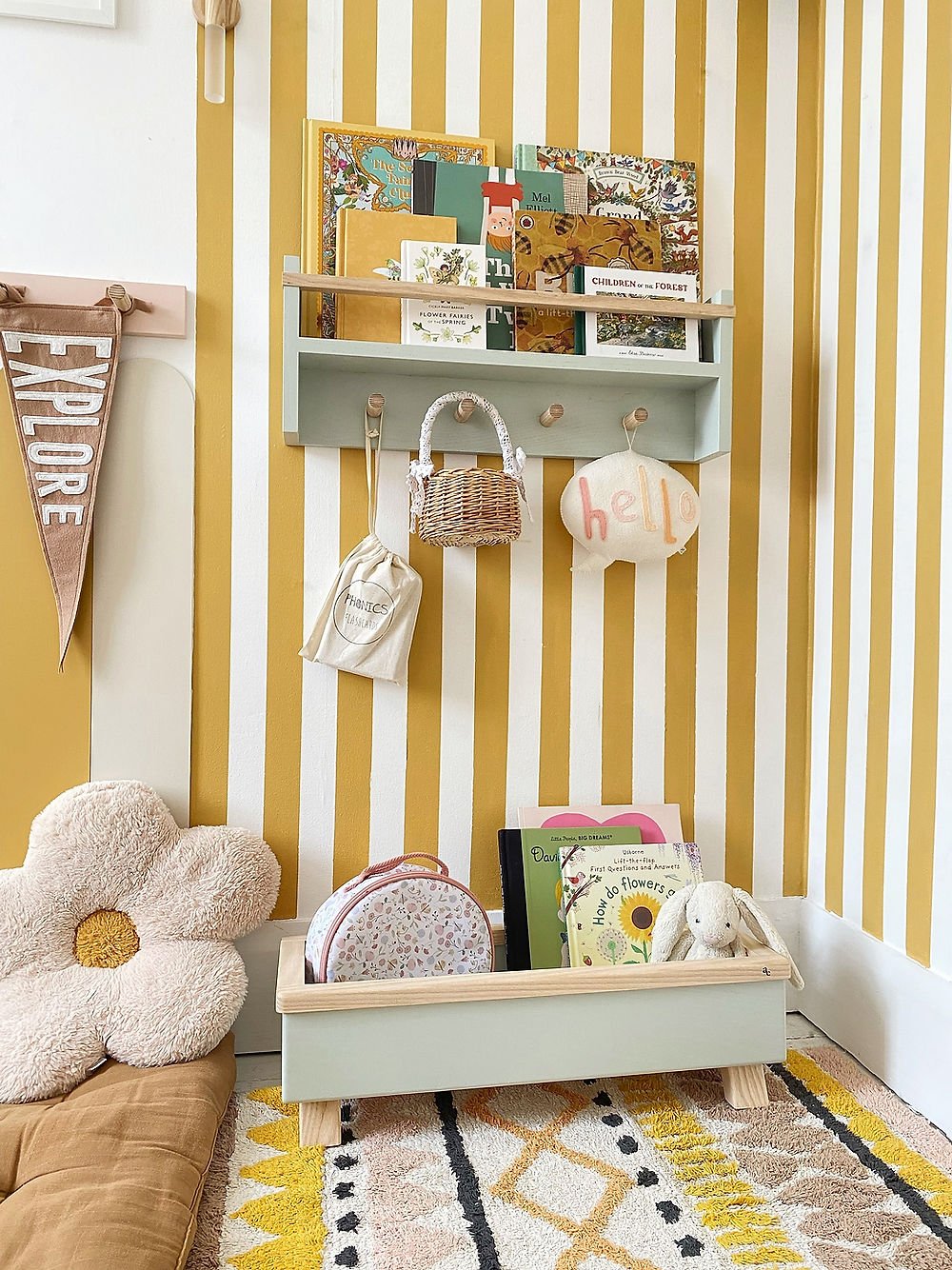 Children's room with yellow and white striped wall, shelves, and toys.