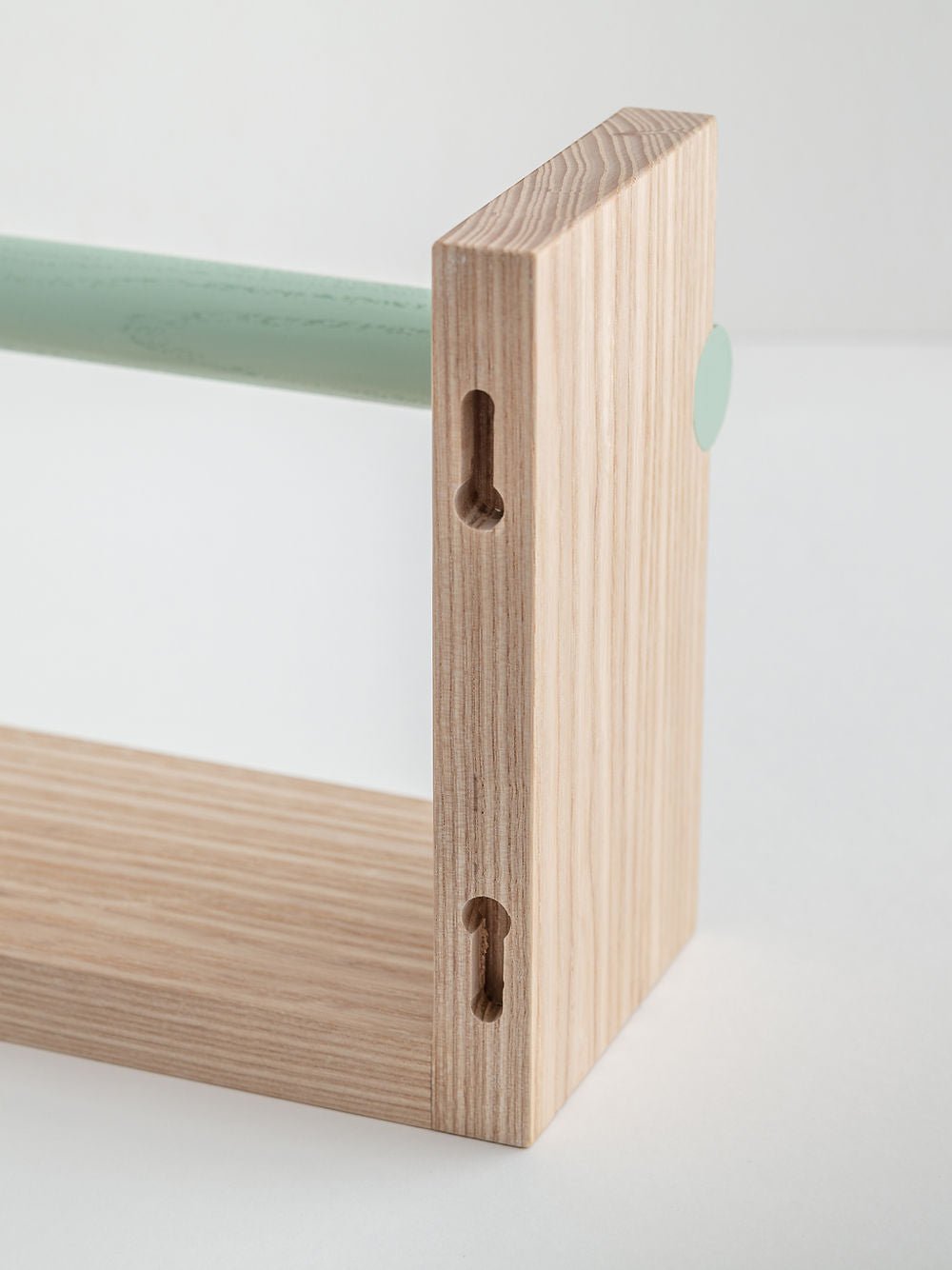 Close-up of a wooden shelf corner with a white background
