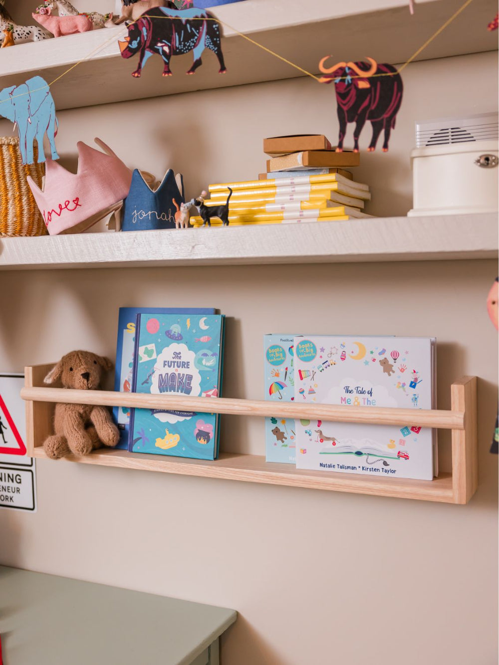 Children's room with shelves displaying books, toys, and decorative items.