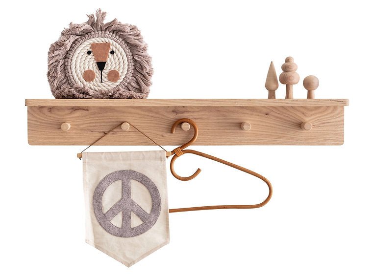 Wooden shelf with decorative items including a peace sign banner and a lion head plush toy.